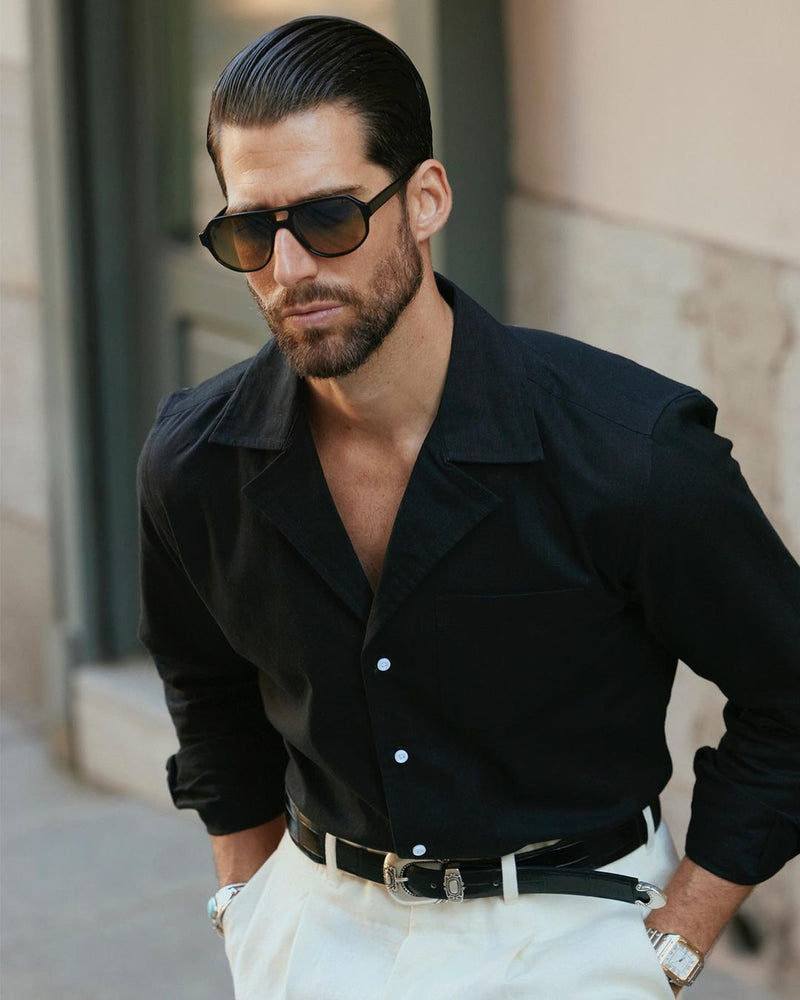 Front close up of model wearing custom linen Gurkha pants for men by Luxire in cream with hands in pockets